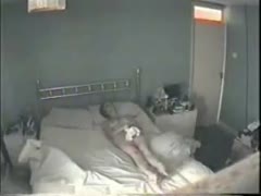 Unaware of a concealed camera, the naked wife masturbates in the bedroom.